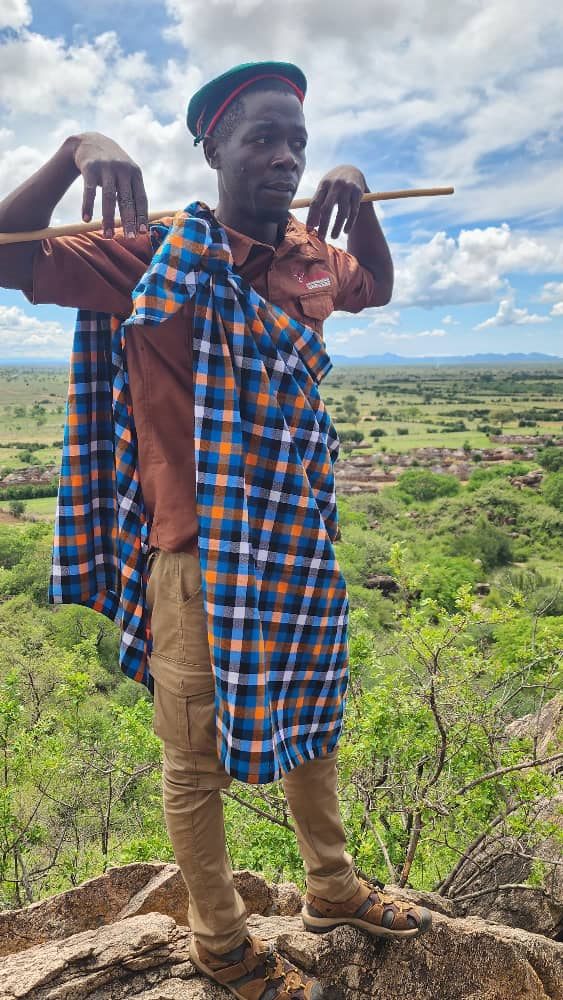 Paius wearing a cultural cloth above a valley