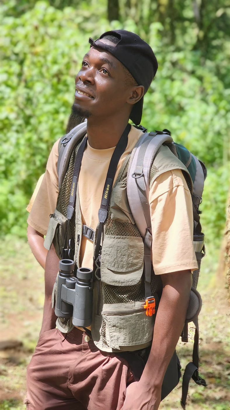 Paius Joshua in the forest with binoculars