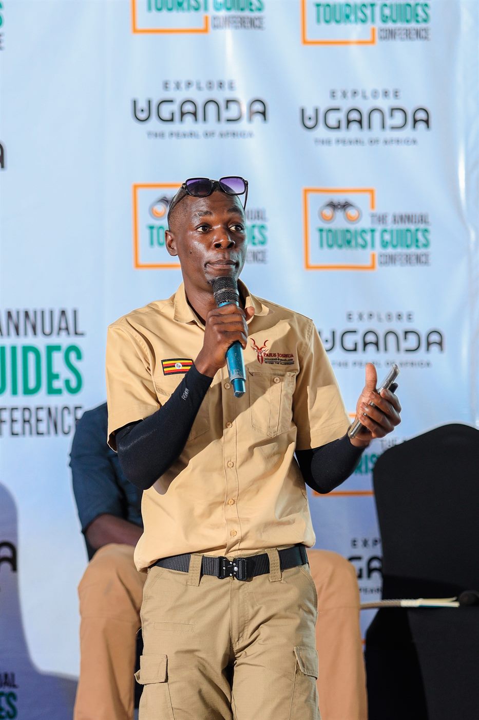 Paius speaking with a microphone at a tourism guide conference