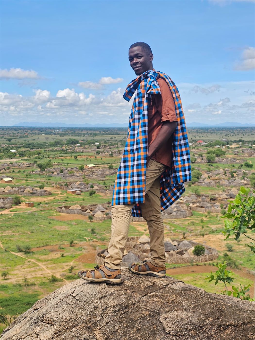 Paius on a rock overlooking a cultural landscape