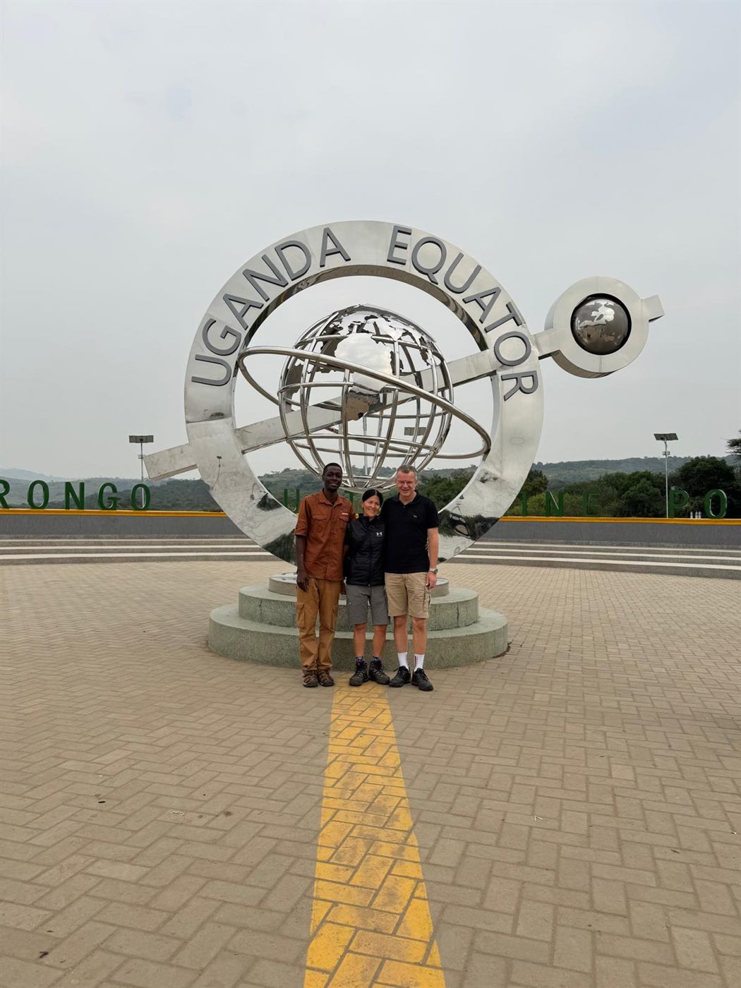 Paius and guests at the Uganda Equator monument