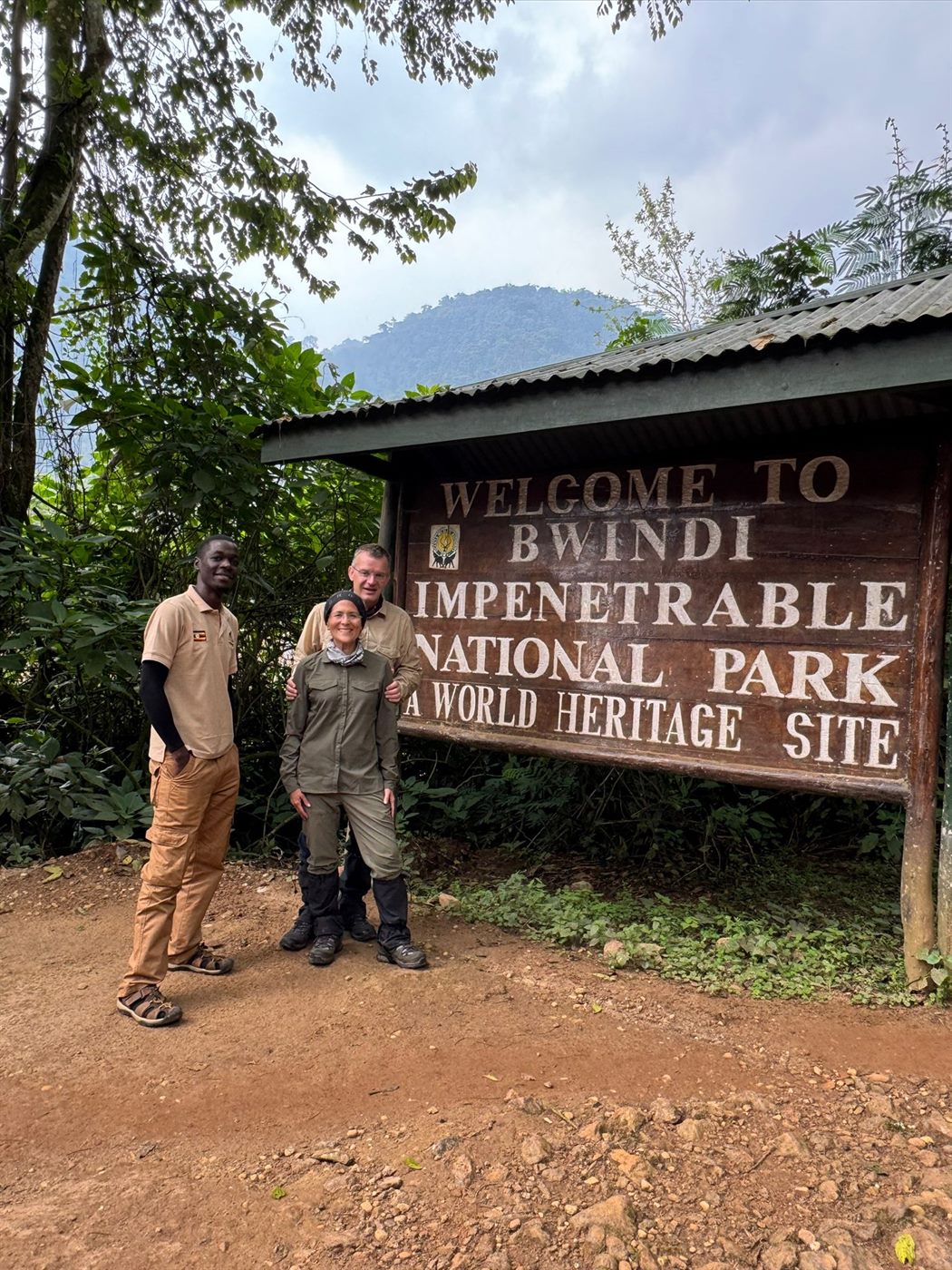 Paius and guests at Bwindi park sign